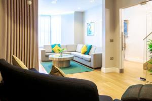 a living room with a couch and a table at Edge14- spacious, stylish and near the beach! in Newquay