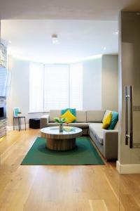 a living room with a couch and a coffee table at Edge14- spacious, stylish and near the beach! in Newquay