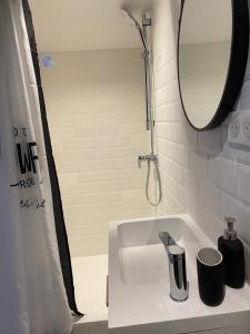 a bathroom with a sink and a mirror and a shower at Petite Maison typique de ville marseille in Marseille