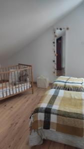 a bedroom with two bunk beds and a bedspread at Duplex Estelle - 2 couples ou famille in Gérardmer