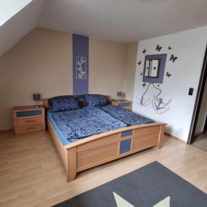 a bedroom with a bed with a blue comforter at Ferienhaus 10 in Tossens in Tossens