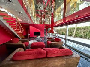 a living room with red walls and red furniture at Merirahu private luxury villa in Tallinn