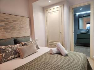 a bedroom with a bed and a bathroom with a sink at FLORIT FLATS - The Apolo Apartment in Valencia