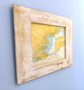 a world map in a wooden frame on a wall at Histoire de Loire - LAYON in Saumur