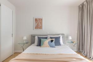 a bedroom with a large bed with two tables at Elegant 2BR Apartment in Kolonaki by UPSTREET in Athens
