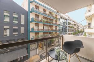 a balcony with a fireplace and two chairs at Elegant 2BR Apartment in Kolonaki by UPSTREET in Athens