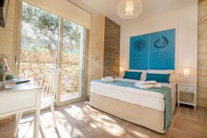 a bedroom with a bed and a large window at Deluxe Crete Villa Villa Rhea 3 Bedroom Private Pool Sea View Chania in Kambiá