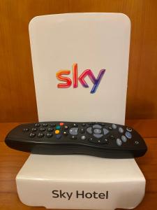 a remote control sitting on top of a sky hotel controller at Hotel Cristallo in Fano