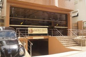 a car parked in front of a building at Hotel Mont Rey in São Vicente