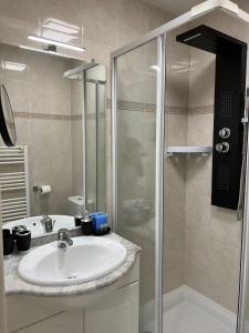 a bathroom with a sink and a shower at Kimi Résidence in Cannes