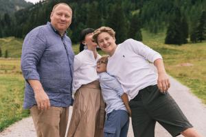 a family posing for a picture on a dirt road at Hotel Steiner Superior in Obertauern