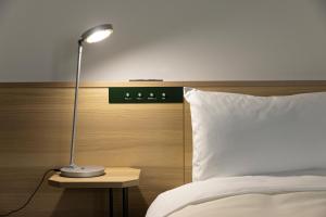 Postel nebo postele na pokoji v ubytování Tokyu Stay Shibuya Shin-Minamiguchi