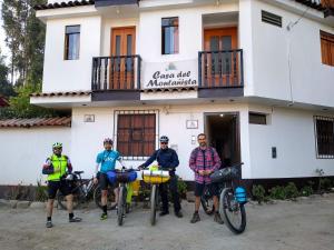 een groep mensen met hun fietsen voor een gebouw bij Hostal Casa del Montañista in Huaraz