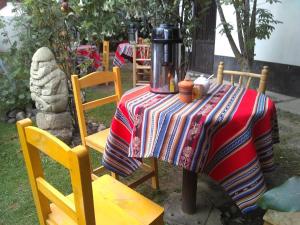a table with a coffee maker on top of it at Hostal Casa del Montañista in Huaraz