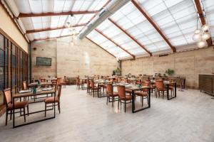 a restaurant with tables and chairs in a room at Exe Astur Plaza in Astorga