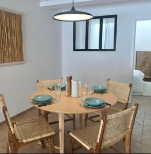 a wooden table with four chairs and a dining room at Accommodation in Sesimbra - Two Double Bedroom in Sesimbra