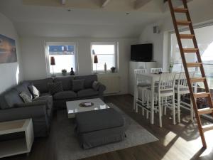 a living room with a couch and a table at Haus ohne Namen Juist in Juist