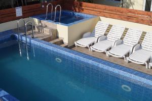a swimming pool with lounge chairs and a swimming pool at Studio Apartments Marija with private parking in Makarska