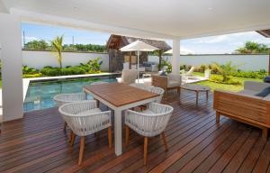 a patio with a table and chairs and a pool at VILLA LILOU, Splendide villa au centre de Grand Baie in Grand Baie +177 photos