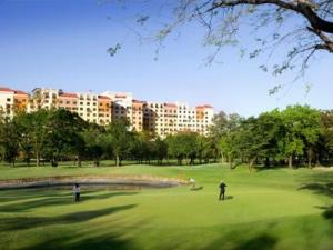 two people playing golf on a green in a park at Queen BR+Mat, Olympic Pool / Near NAIA T3 in Manila