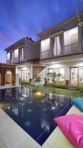 a house with a swimming pool in front of it at Maharani Residence in Denpasar