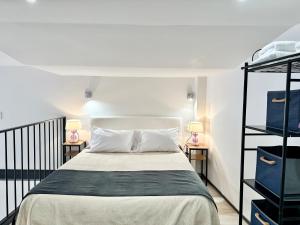 a bedroom with a bed and two night stands at Loft Marbella Center in Marbella