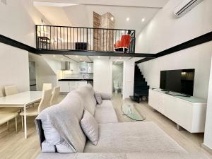 a living room with a couch and a dining room at Loft Marbella Center in Marbella