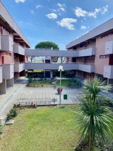 an apartment building with a park in front of it at Premium Apartment Bilo C2 in Marina di Bibbona