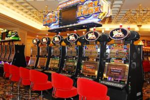 a bunch of slot machines in a casino at Queen BR+Mat, Olympic Pool / Near NAIA T3 in Manila