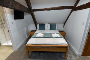 a bedroom with a bed with blue pillows at Alfred Russel Wallace Restaurant with Rooms in Usk
