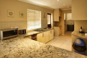 a kitchen with a granite counter top in a room at Galico Holiday Home in Langebaan