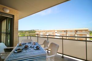 a table and chairs on a balcony with a view at Mediterranean Way - Maldivas in La Pineda