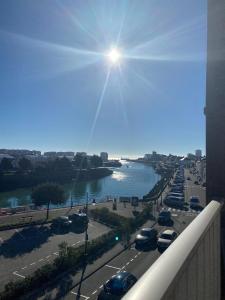 a view of a highway with a river and cars at Studio vue sur mer in La Chaume