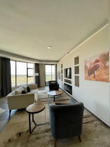 a living room with couches and tables in a room at A Scenic Escape within Nairobi in Nairobi