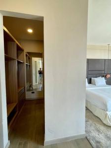 a bedroom with a large bed and a mirror at A Scenic Escape within Nairobi in Nairobi