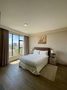 a bedroom with a large bed and a large window at A Scenic Escape within Nairobi in Nairobi