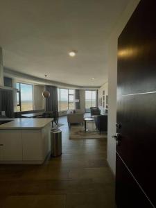 a room with a kitchen and a living room at A Scenic Escape within Nairobi in Nairobi