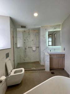 a bathroom with a shower and a toilet and a sink at A Scenic Escape within Nairobi in Nairobi