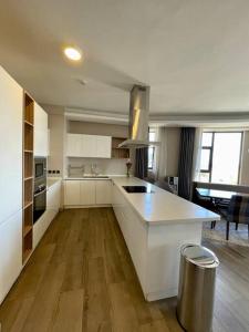 a large kitchen with white cabinets and a counter top at A Scenic Escape within Nairobi in Nairobi