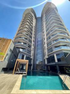 two tall buildings with a swimming pool in front of them at A Scenic Escape within Nairobi in Nairobi