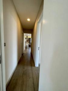 a hallway of an apartment with white walls and wood floors at A Scenic Escape within Nairobi in Nairobi