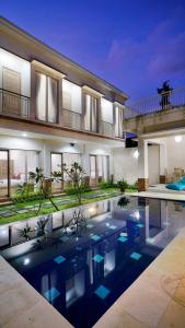 a house with a swimming pool in front of a house at Maharani Residence in Denpasar