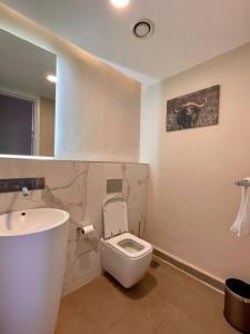 a bathroom with a white toilet and a sink at A Scenic Escape within Nairobi in Nairobi