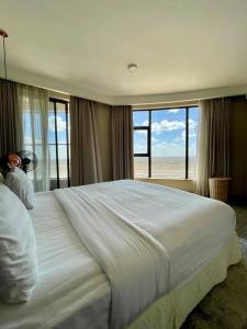 a bedroom with a large bed with a view of the ocean at A Scenic Escape within Nairobi in Nairobi