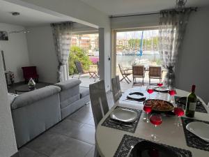 a dining room with a table with wine glasses on it at MARINA in Cap d'Agde