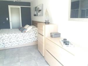 a bedroom with a bed and a dresser at MARINA in Cap d'Agde