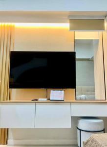 a large flat screen tv on a wall at Stunning Bayview Studio in Cebu in Guizo