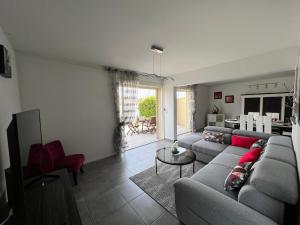 a living room with a couch and a table at MARINA in Cap d'Agde