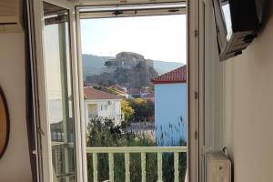 a room with a window with a view of a mountain at Hotel Ilion in Petra