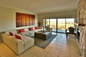 a living room with a couch and a fireplace at Bayview 8 Sleeper Langebaan in Langebaan